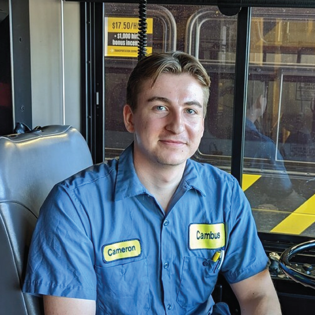 Cameron poses in a bus
